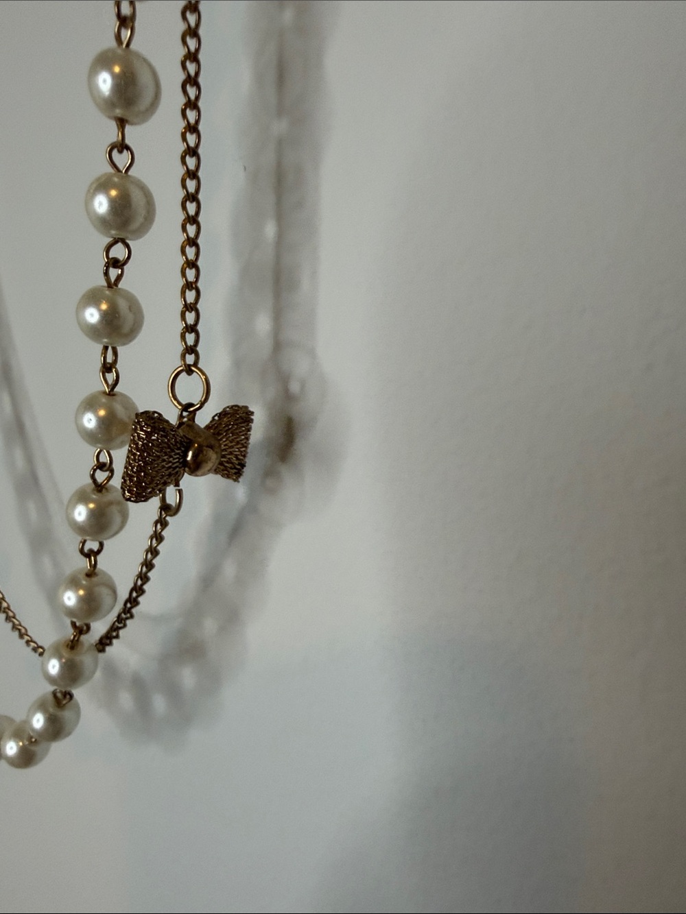 Layered Cream Pearl Style Necklace with Gold-Tone Chain with Bow Accents
